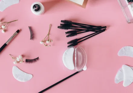 Flat lay of lash extensions, eye pads, and beauty tools