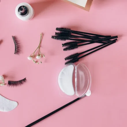 Flat lay of lash extensions, eye pads, and beauty tools