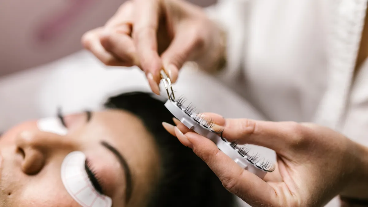 Close-up of eyelash extension application on a client