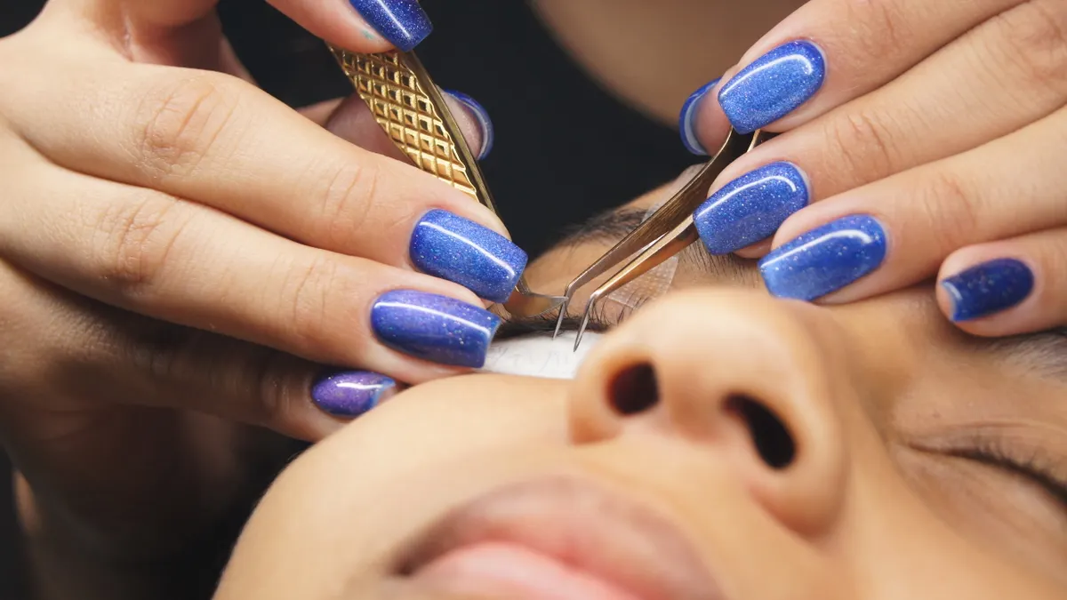 How Lash Extensions Are Applied: Step-by-Step for First-Timers Close-up of eyelash extension application with tweezers