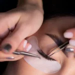 Eyelash extension being applied to a closed eye