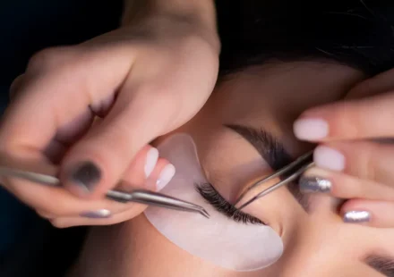 Eyelash extension being applied to a closed eye
