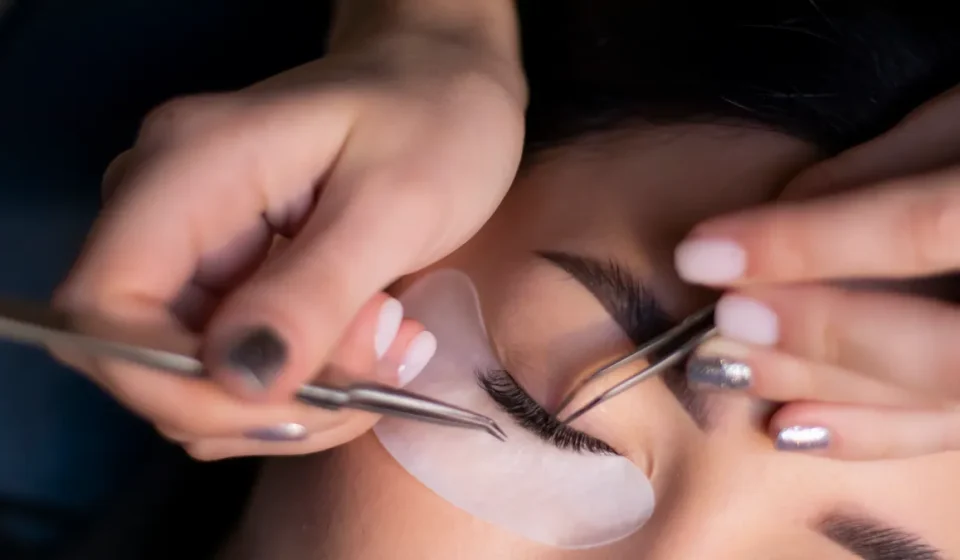 Eyelash extension being applied to a closed eye